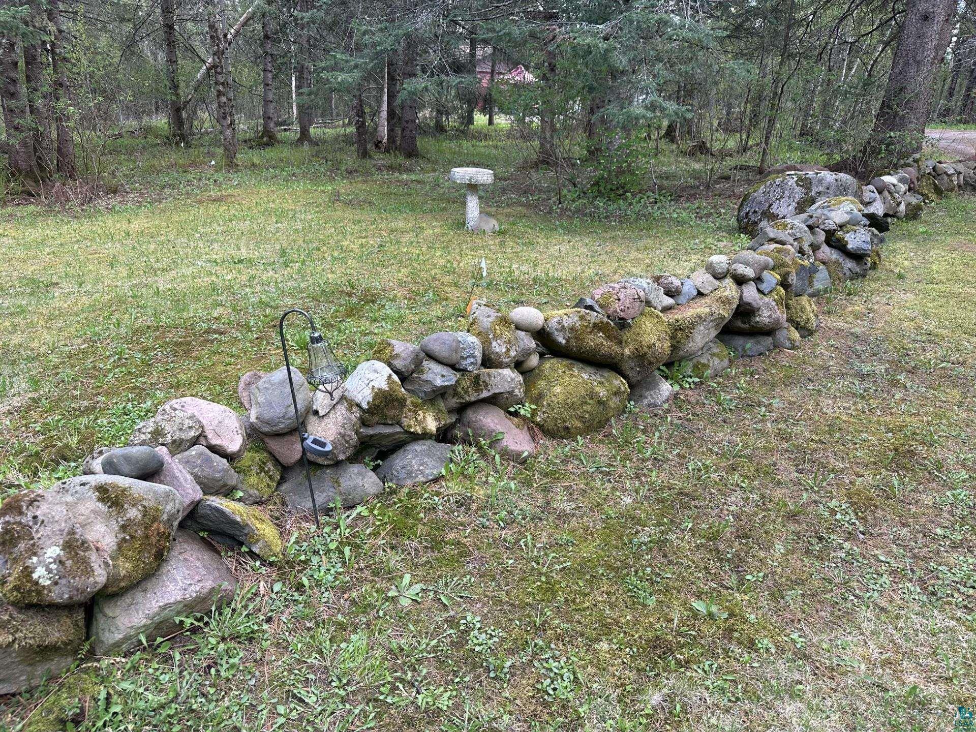 81 Hautaluoma Road Esko, MN 55733 - Photo 39 of 43 Stone wall border with natural moss accents