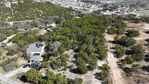 an aerial view of a house with a yard and garden