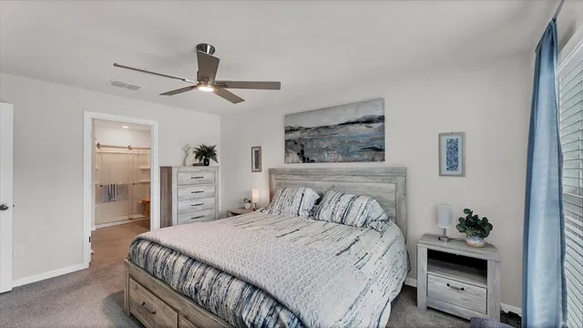 a bedroom with a large bed and a chandelier