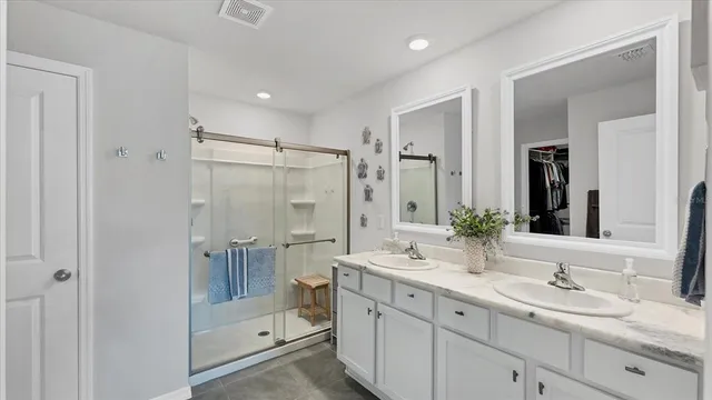 a bathroom with a shower sink double and mirror