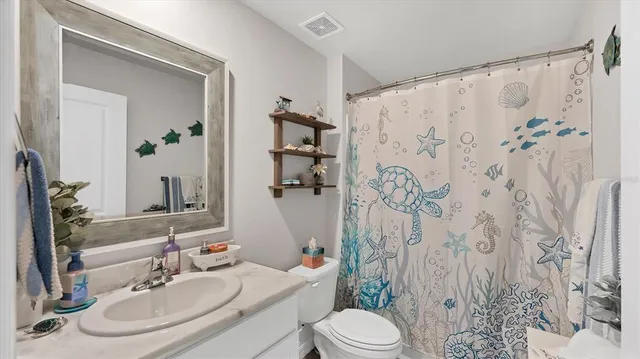 a bathroom with a sink toilet a mirror and shower