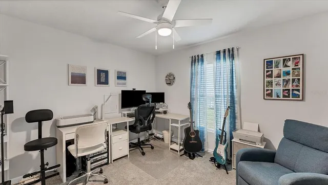 a view of a livingroom with workspace and a couch