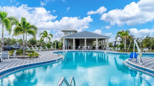 a view of a swimming pool with lounge chairs in patio