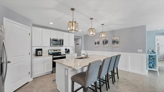 a kitchen with refrigerator cabinets dining table and chairs