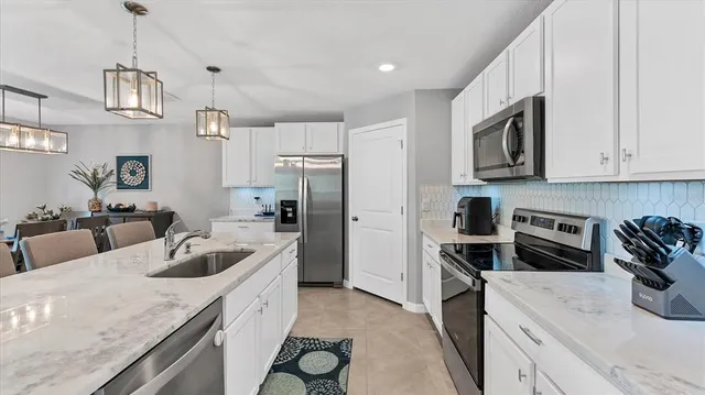 a kitchen with a sink stove and refrigerator