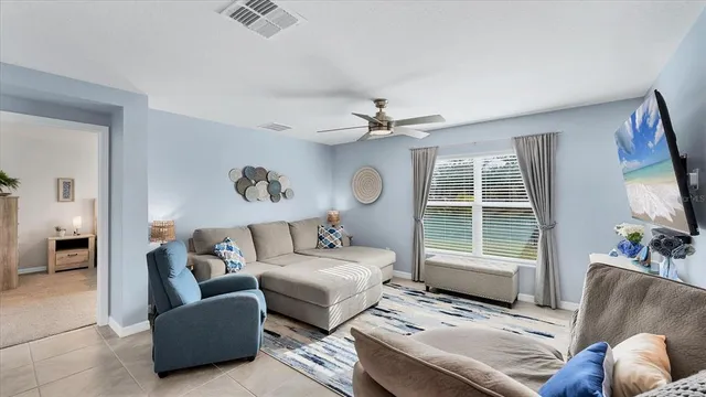 a living room with furniture and a large window