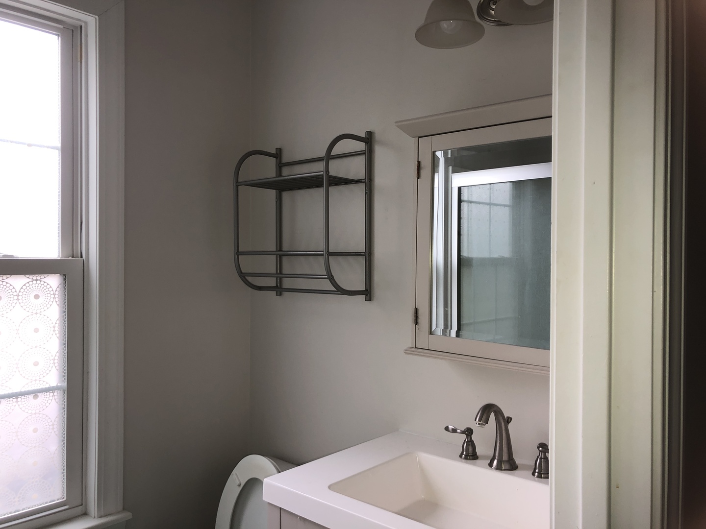 321 North Quincy Street Clinton, IL 61727 - Photo 11 of 12 a bathroom with a sink and mirror