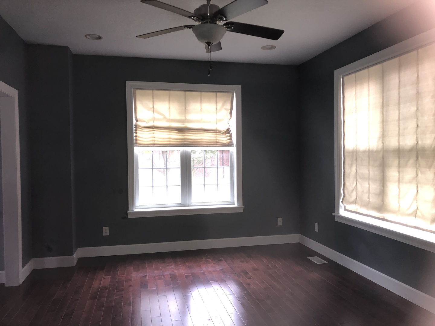 321 North Quincy Street Clinton, IL 61727 - Photo 2 of 12 a view of an empty room with wooden floor and a window