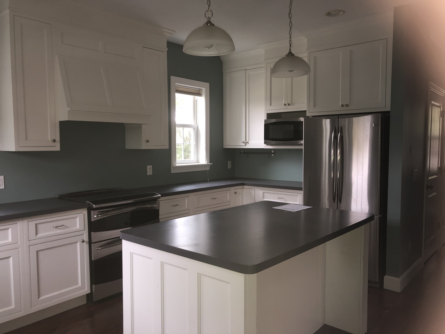 321 North Quincy Street Clinton, IL 61727 - Photo 4 of 12 a kitchen with kitchen island a counter space a sink a refrigerator and cabinets