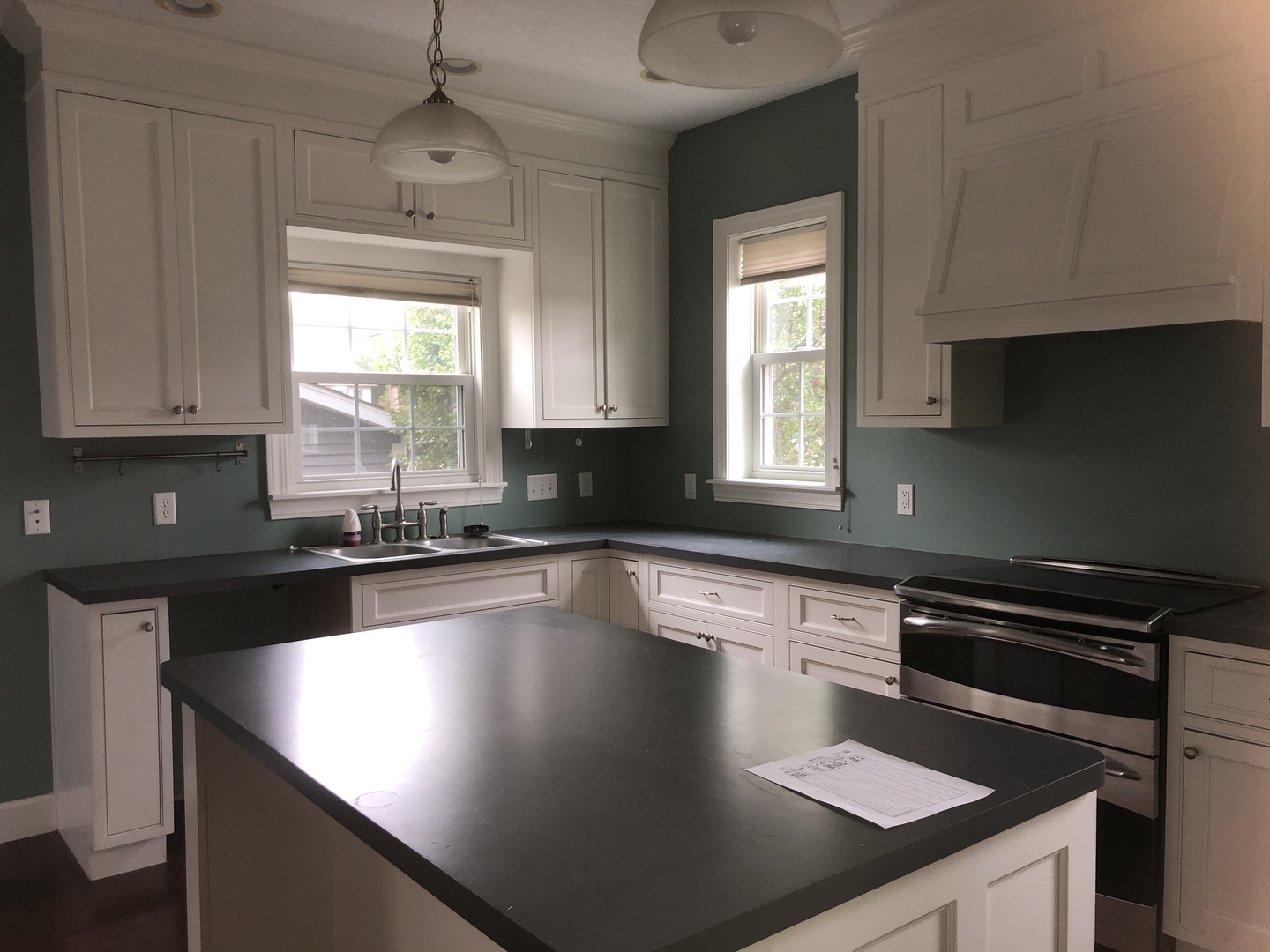 321 North Quincy Street Clinton, IL 61727 - Photo 5 of 12 a kitchen with granite countertop a sink a stove and cabinets