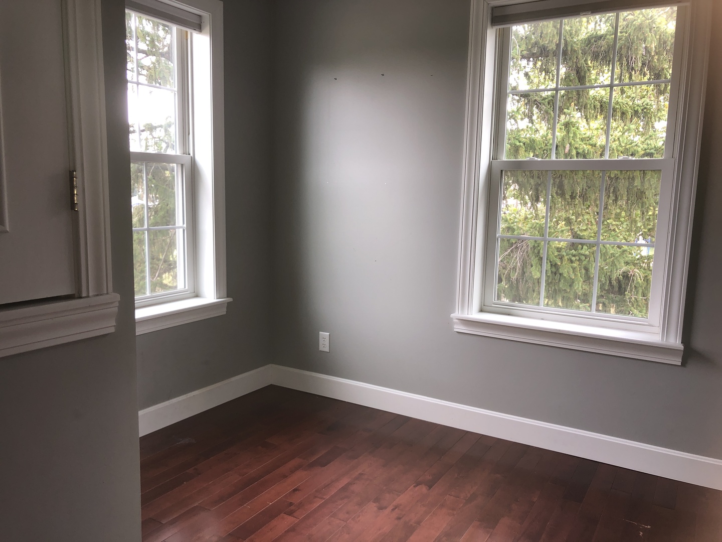 321 North Quincy Street Clinton, IL 61727 - Photo 6 of 12 an empty room with wooden floor and windows