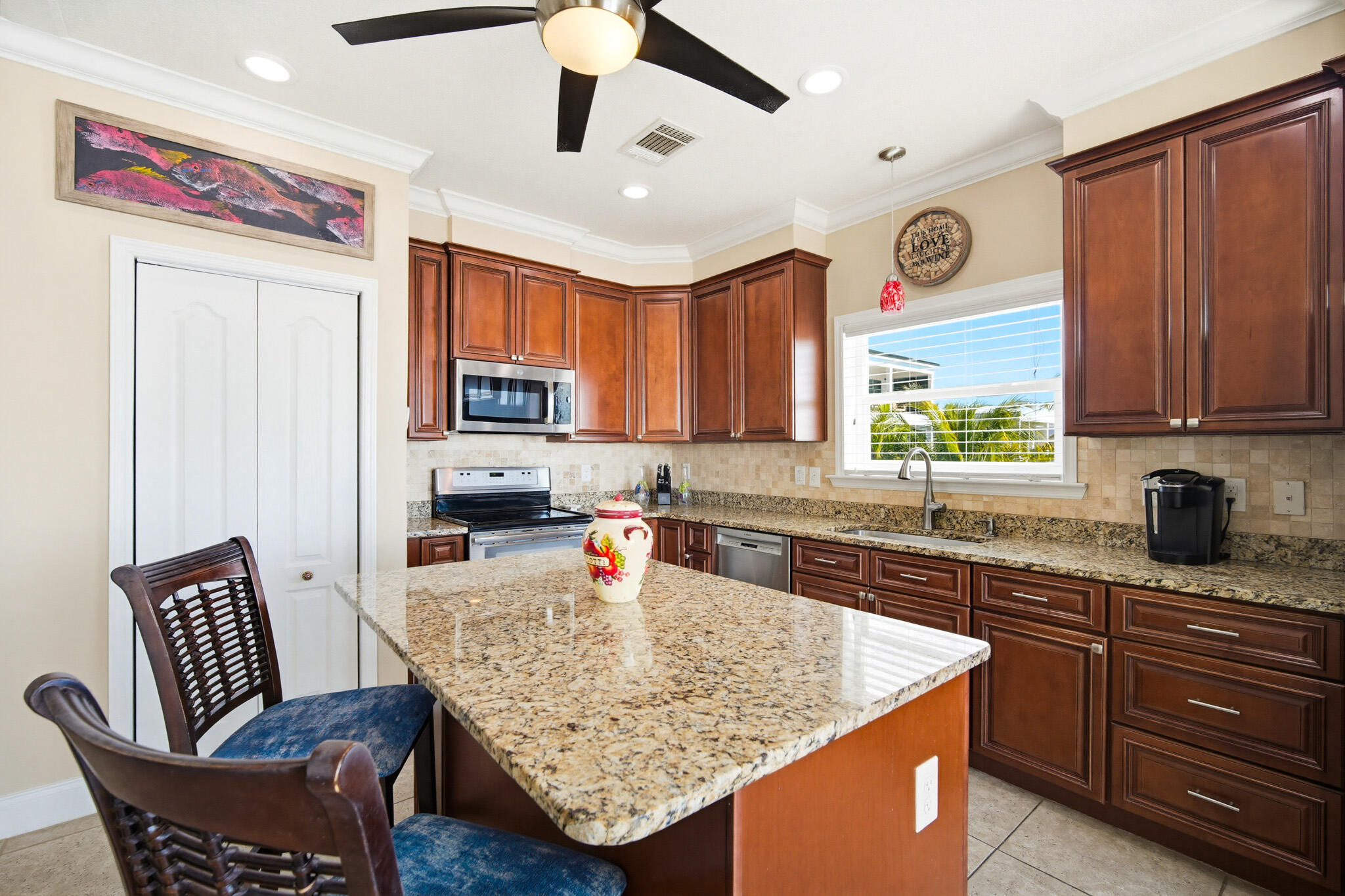 183 Star Lane Key West, FL 33040 - Photo 20 of 70 a kitchen with stainless steel appliances granite countertop a sink dishwasher stove and refrigerator with wooden floor