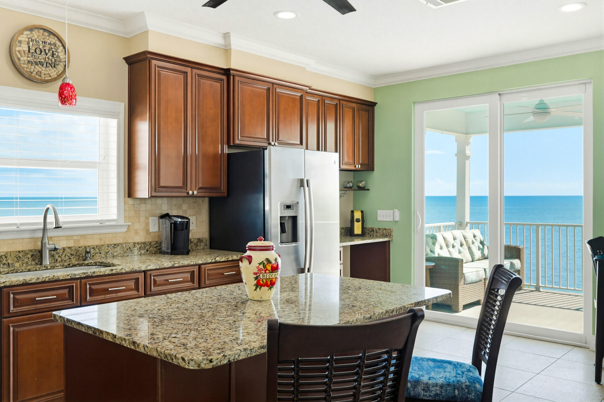 183 Star Lane Key West, FL 33040 - Photo 30 of 70 a kitchen with granite countertop a dining table chairs and a refrigerator