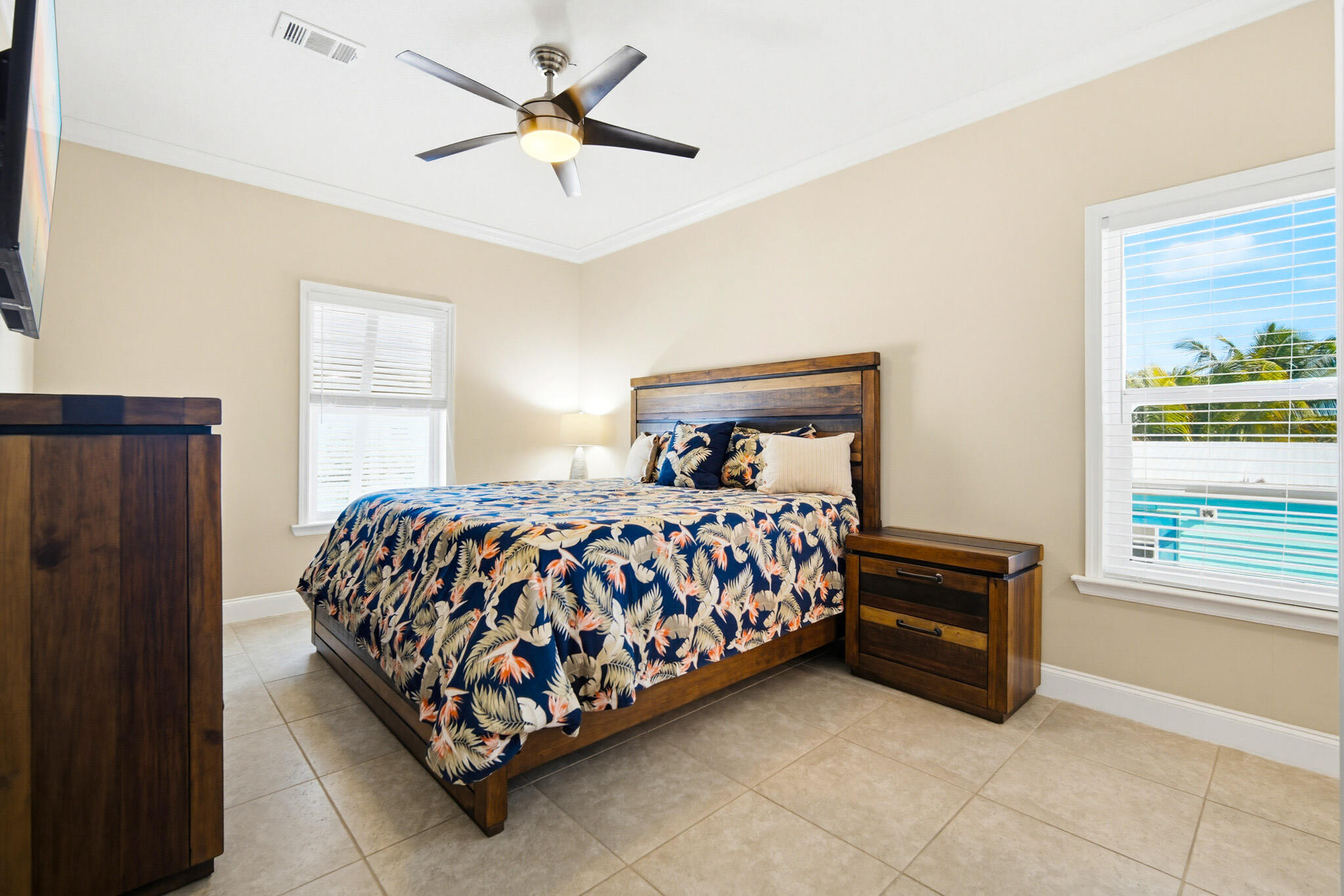 183 Star Lane Key West, FL 33040 - Photo 32 of 70 a bed sitting in a bedroom next to a window and a chandelier