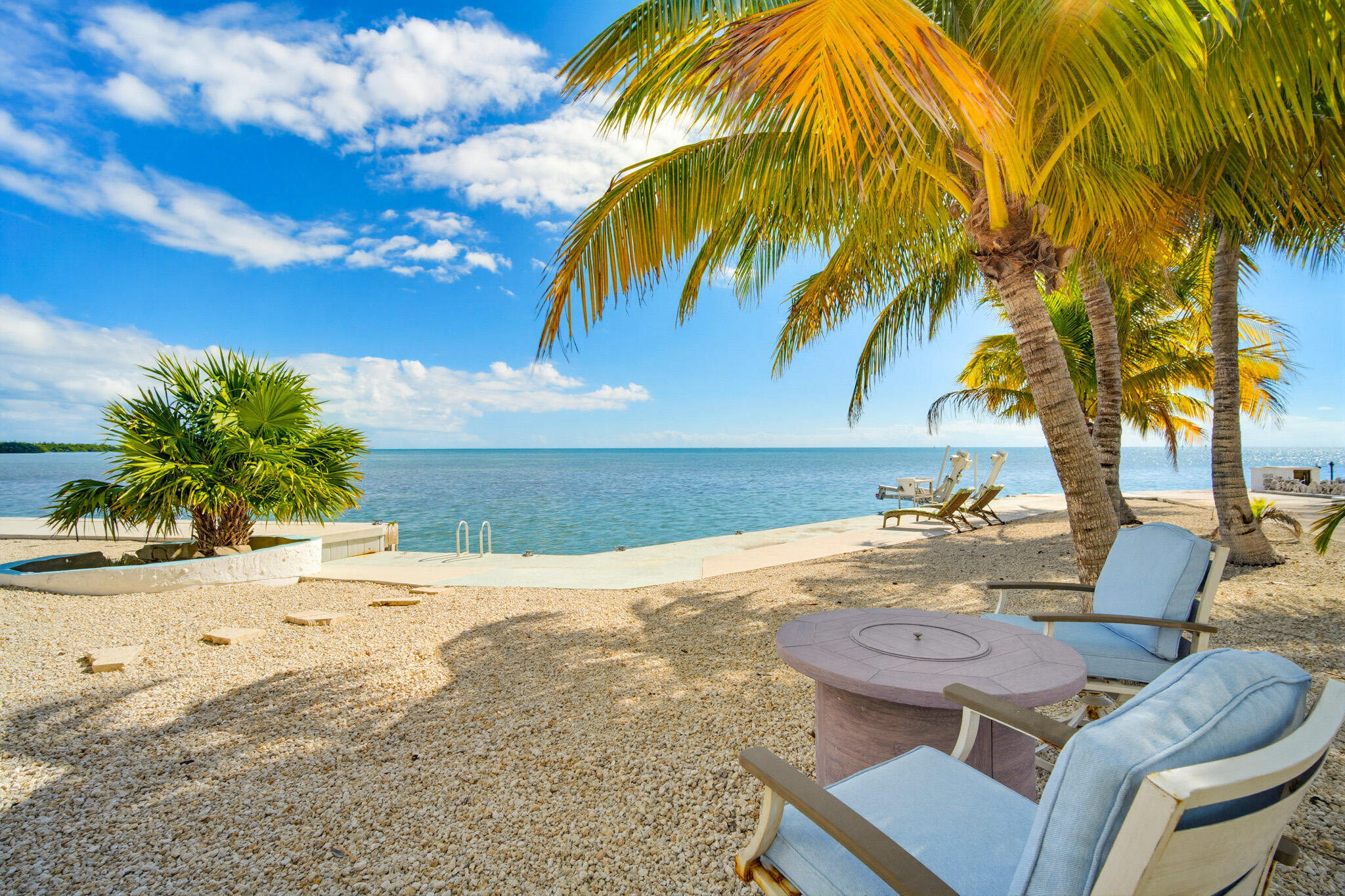 183 Star Lane Key West, FL 33040 - Photo 56 of 70 a view of a backyard with table and chairs under a large tree