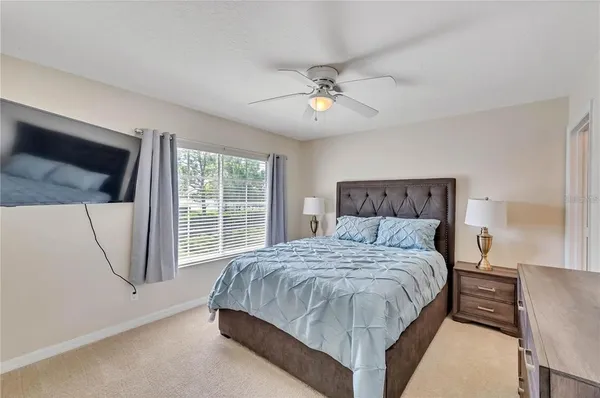 a bedroom with a large bed and a chandelier