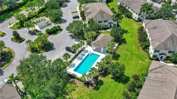 an aerial view of a house with garden space and street view