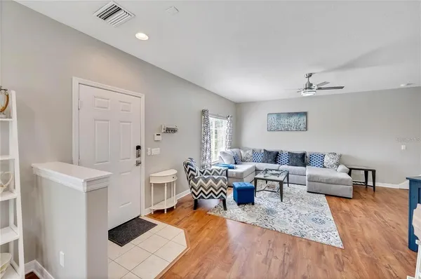 a living room with furniture and wooden floor