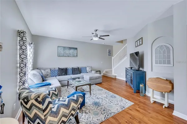 a living room with furniture and wooden floor
