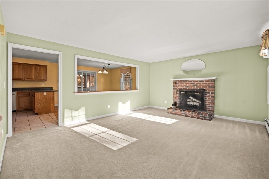 74 Higgins Road Kingston, MA 02364 - Photo 11 of 35 an empty room with furniture and a fireplace