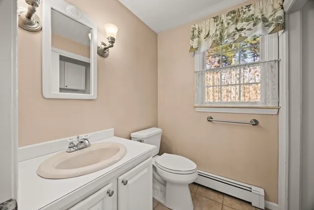 a bathroom with a sink a toilet and a mirror