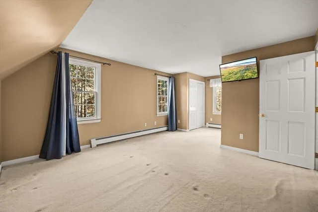 an empty room with closet and a window