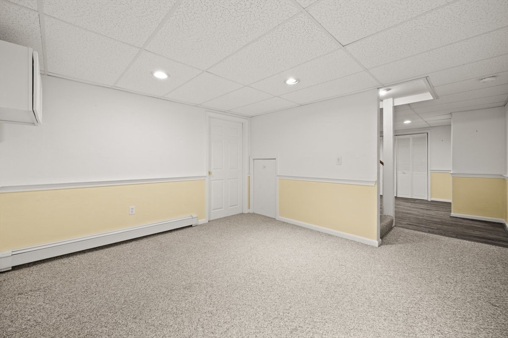 74 Higgins Road Kingston, MA 02364 - Photo 28 of 35 an empty room with a cabinet and a refrigerator