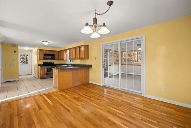 a view of a kitchen with wooden floor and a kitchen
