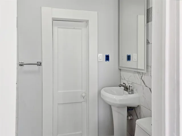 a view of empty room with window and wooden floor