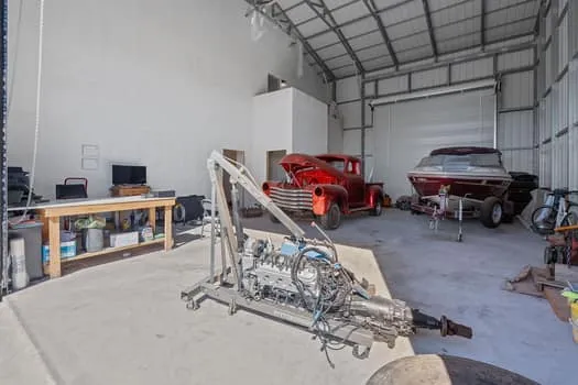 a backyard of a house with machine and chairs