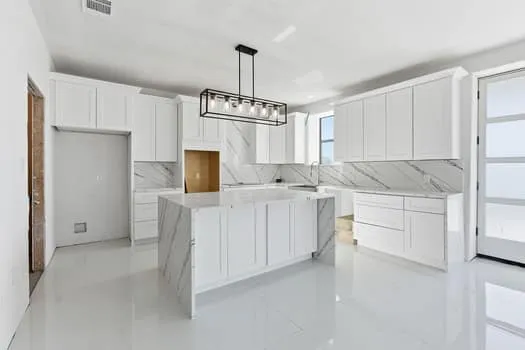 a kitchen with white cabinets and white appliances