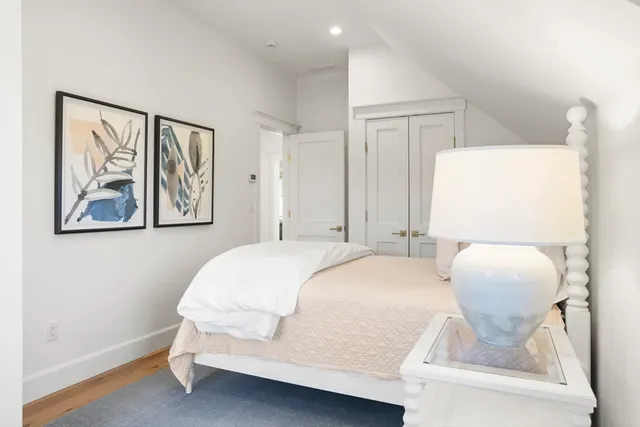 a bedroom with a bed and a painting on the wall