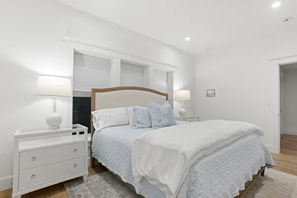 a bedroom with a bed and a night stand
