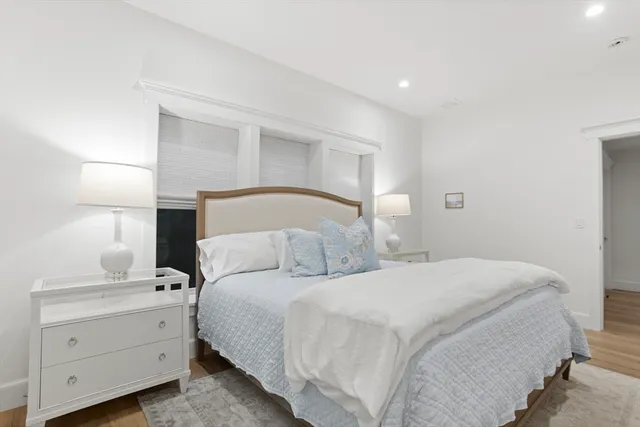 a bedroom with a bed and a night stand