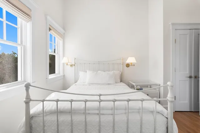 a bedroom with a bed and a painting on the wall