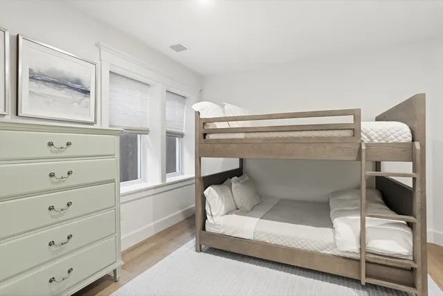 a bedroom with a bunk bed and a window
