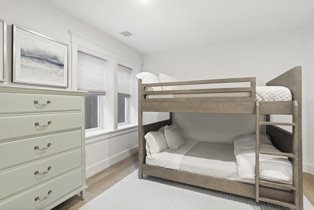 13 A Gingy Lane Nantucket, MA 02554 - Photo 26 of 29 a bedroom with a bunk bed and a window