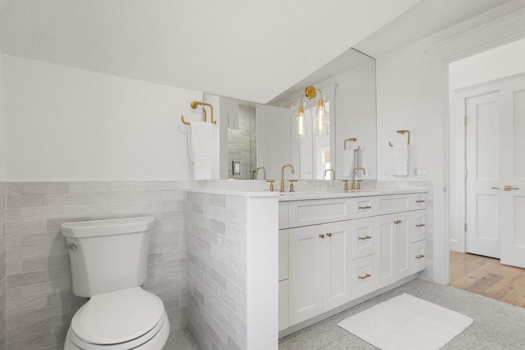 13 A Gingy Lane Nantucket, MA 02554 - Photo 27 of 29 a bathroom with a granite countertop toilet sink and mirror