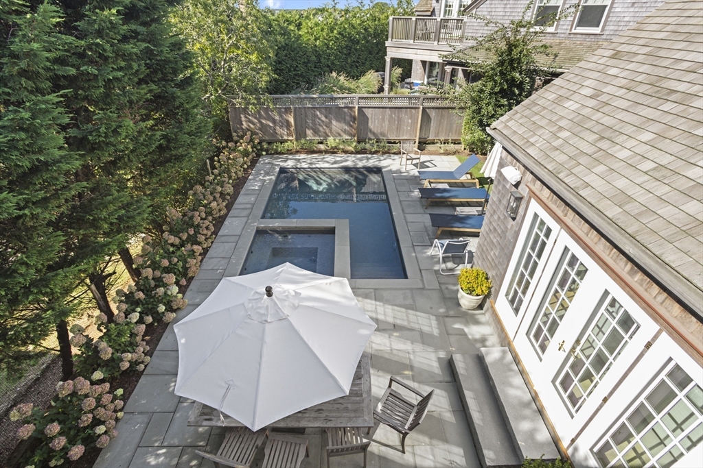 13 A Gingy Lane Nantucket, MA 02554 - Photo 28 of 29 a view of a patio with table and chairs with wooden floor and fence