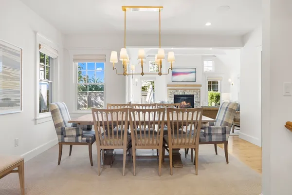 a dining room with furniture a chandelier and window