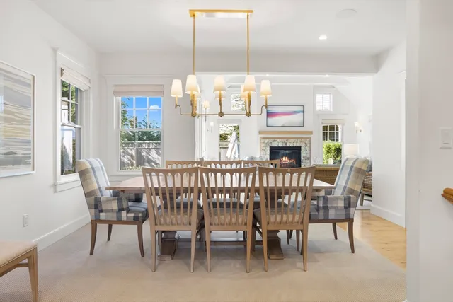 a dining room with furniture a chandelier and window