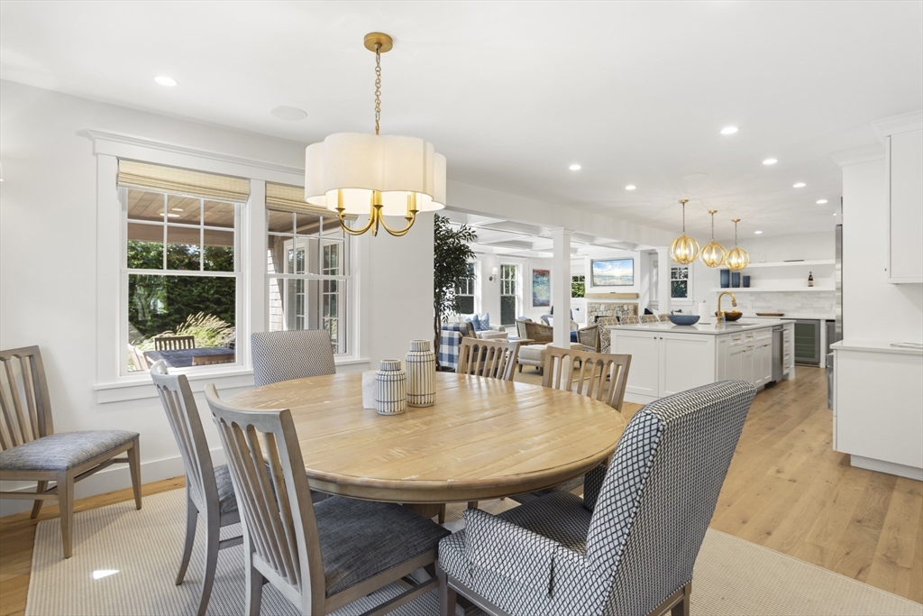13 A Gingy Lane Nantucket, MA 02554 - Photo 6 of 29 a dining room with furniture a chandelier and wooden floor