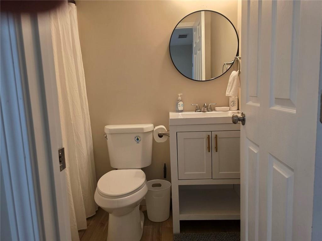 722 Lacy Street Monroe, GA 30655 - Photo 17 of 19 a bathroom with a toilet a sink and a mirror