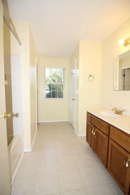 1270 W Road Clarksville, TN 37040 - Photo 4 of 25 a spacious bathroom with a granite countertop sink a mirror and a bathtub