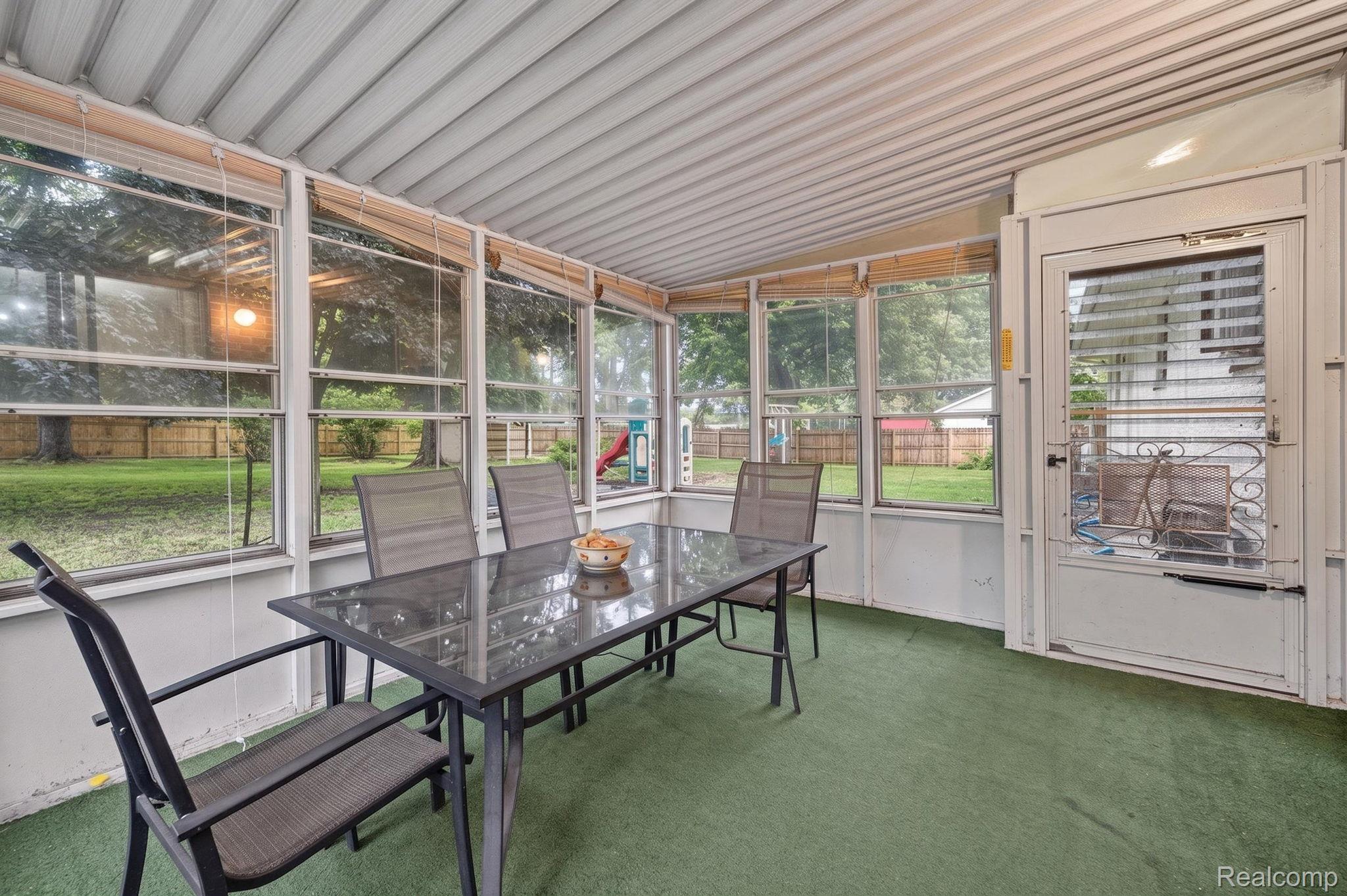 5330 Sheridan Road Saginaw, MI 48601 - Photo 26 of 50 Screened porch featuring a green carpeted floor and a white paneled ceiling
