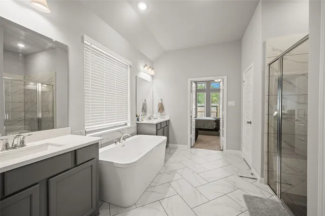 a spacious bathroom with a double vanity sink a large mirror and a shower