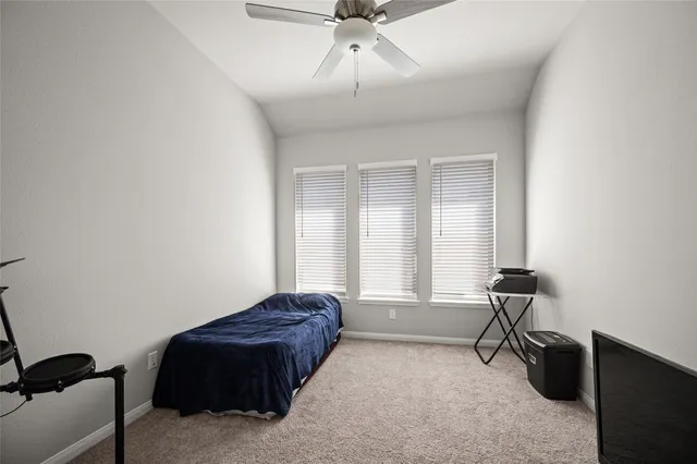 a spacious bedroom with a bed and a chandelier