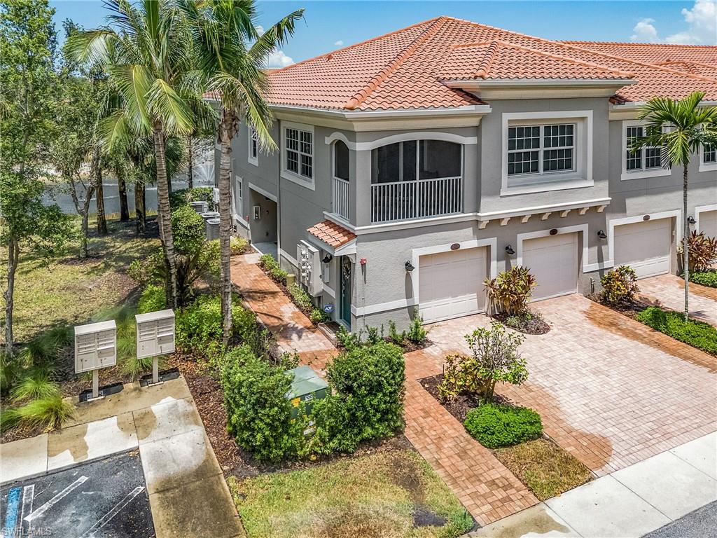 23550 Alamanda Drive, Unit 202 Estero, FL 34135 - Photo 2 of 26 a front view of a house with garden