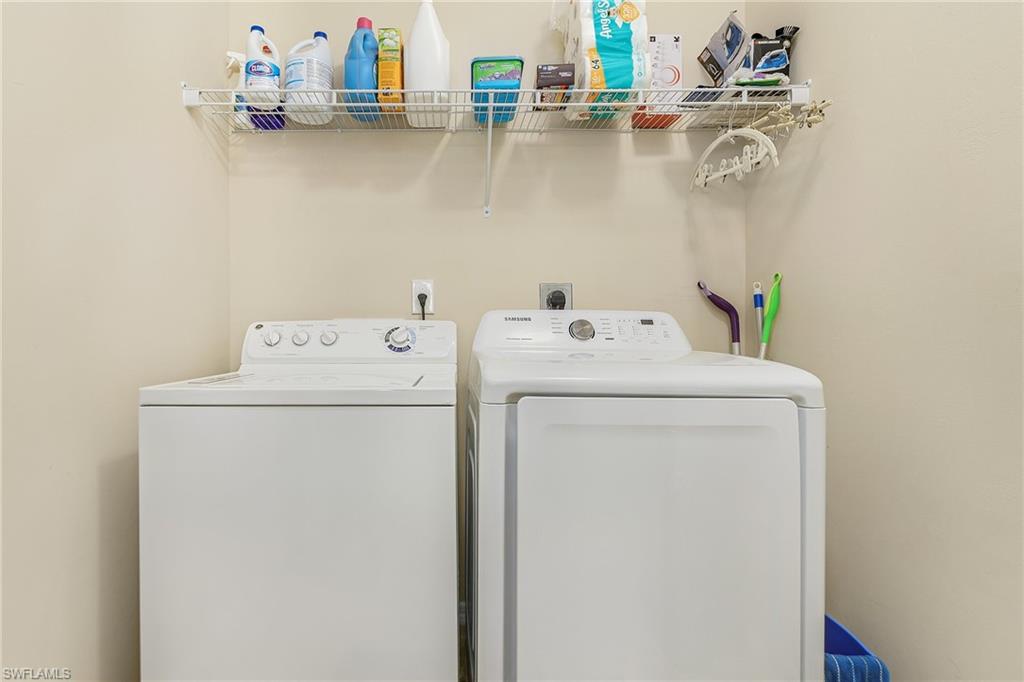 23550 Alamanda Drive, Unit 202 Estero, FL 34135 - Photo 21 of 26 a utility room with dryer and washer