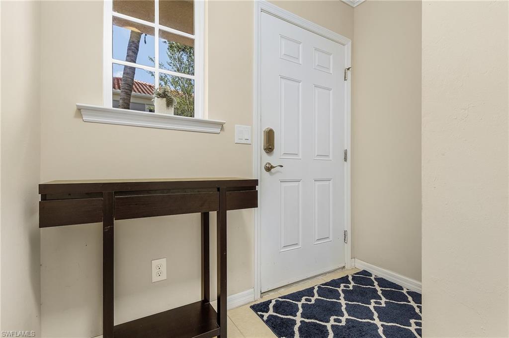 23550 Alamanda Drive, Unit 202 Estero, FL 34135 - Photo 6 of 26 a view of an entryway with wooden floor